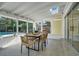 Enclosed porch dining area overlooks a pool at 1926 Natalen Rd, Winter Park, FL 32792