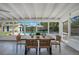 Enclosed porch with dining table and seating overlooking the backyard pool at 1926 Natalen Rd, Winter Park, FL 32792