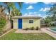 Backyard shed with blue door and well-maintained landscaping at 1926 Natalen Rd, Winter Park, FL 32792