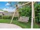 Backyard image shows a wooden swing set underneath a leafy tree and greenery at 1926 Natalen Rd, Winter Park, FL 32792