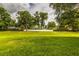Expansive backyard with lush green grass and a white fence bordering the property at 2031 Wekiva Reserve Blvd, Apopka, FL 32703