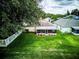 Lush backyard featuring a screened-in porch and mature landscaping at 2031 Wekiva Reserve Blvd, Apopka, FL 32703