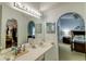 Bright bathroom with dual sinks, a large mirror, and a doorway to the main bedroom at 2031 Wekiva Reserve Blvd, Apopka, FL 32703