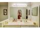 Bright bathroom featuring a large mirror reflecting a view into the walk-in closet at 2031 Wekiva Reserve Blvd, Apopka, FL 32703