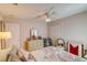 Bedroom with ceiling fan, floral comforter on the bed, and a vintage dresser with a mirror at 2031 Wekiva Reserve Blvd, Apopka, FL 32703