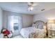 Cozy bedroom with a decorative fan and a window that brings in natural light at 2031 Wekiva Reserve Blvd, Apopka, FL 32703