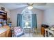 Charming bedroom featuring a vaulted ceiling, a fan, and a window with blue curtains at 2031 Wekiva Reserve Blvd, Apopka, FL 32703