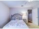 Cozy bedroom featuring a decorative floral comforter, butterfly pillow, and a vintage metal headboard at 2031 Wekiva Reserve Blvd, Apopka, FL 32703