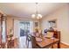 Well-lit dining room features wood floors and sliding door access to the outdoor patio at 2031 Wekiva Reserve Blvd, Apopka, FL 32703