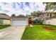 Charming single-story home featuring a well-manicured lawn, two car garage, and bright red front door at 2031 Wekiva Reserve Blvd, Apopka, FL 32703