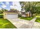 House featuring a well-maintained lawn and convenient two-car garage, ensuring ample parking at 2031 Wekiva Reserve Blvd, Apopka, FL 32703