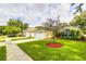View of the home's manicured lawn, complemented by a young tree and well-maintained landscaping at 2031 Wekiva Reserve Blvd, Apopka, FL 32703