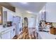 Kitchen featuring white cabinetry, hardwood floors, and modern appliances at 2031 Wekiva Reserve Blvd, Apopka, FL 32703