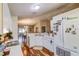 Open kitchen layout with white cabinets, stainless sink, and view of the dining area at 2031 Wekiva Reserve Blvd, Apopka, FL 32703