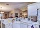 Clean, functional kitchen with white countertops, stainless sink, and view of dining area at 2031 Wekiva Reserve Blvd, Apopka, FL 32703