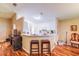 Kitchen counter with barstool seating and a view of the adjacent dining area at 2031 Wekiva Reserve Blvd, Apopka, FL 32703