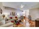 Bright living room with hardwood flooring, a comfortable seating area, and arched doorways at 2031 Wekiva Reserve Blvd, Apopka, FL 32703