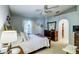 Bright bedroom features a ceiling fan, a large window, and an ensuite walk in closet at 2031 Wekiva Reserve Blvd, Apopka, FL 32703