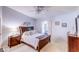 Comfortable bedroom with ceiling fan, window, and wooden furniture at 2031 Wekiva Reserve Blvd, Apopka, FL 32703