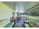 Enclosed patio featuring wicker furniture, including a green sofa, with a view of the backyard at 2031 Wekiva Reserve Blvd, Apopka, FL 32703