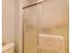 Bathroom with a shower and glass door, tiled walls and a decorative rug at 2031 Wekiva Reserve Blvd, Apopka, FL 32703