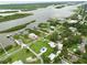 Aerial view of a home in a residential area by the river, featuring a well-maintained yard and lush surroundings at 216 N Riverside Dr, Edgewater, FL 32132