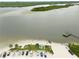 Aerial view of a beach area with parking, beach access, and people enjoying the waterfront at 216 N Riverside Dr, Edgewater, FL 32132