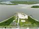 Aerial view showcasing a beachfront park with parking, beach access, and recreational areas by the water at 216 N Riverside Dr, Edgewater, FL 32132