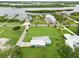 Aerial view of a waterfront property with a lush lawn, featuring a home near docks and a serene river at 216 N Riverside Dr, Edgewater, FL 32132
