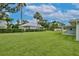 Spacious backyard featuring lush green grass and mature trees, perfect for outdoor gatherings at 216 N Riverside Dr, Edgewater, FL 32132