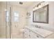 Bathroom featuring a glass shower, vanity with marble countertop, and updated fixtures at 216 N Riverside Dr, Edgewater, FL 32132