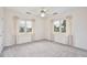 Neutral bedroom featuring two bright windows and a ceiling fan at 216 N Riverside Dr, Edgewater, FL 32132
