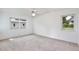 Well-lit bedroom featuring two windows and a ceiling fan at 216 N Riverside Dr, Edgewater, FL 32132