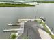 Aerial view of a public boat ramp with docks, parking, and a covered shelter by the water at 216 N Riverside Dr, Edgewater, FL 32132