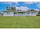Charming single-story home featuring a well-manicured lawn and appealing architectural design at 216 N Riverside Dr, Edgewater, FL 32132