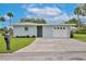 Quaint single-story house with a garage and green lawn, offering comfort and practicality at 216 N Riverside Dr, Edgewater, FL 32132