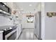 Bright kitchen with white cabinets, stainless steel appliances, and speckled flooring at 216 N Riverside Dr, Edgewater, FL 32132