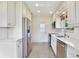 Clean kitchen showcasing white cabinets, stainless steel appliances, and bright lighting at 216 N Riverside Dr, Edgewater, FL 32132