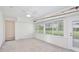 Bright room featuring a ceiling fan, large windows, and access to the outdoors at 216 N Riverside Dr, Edgewater, FL 32132