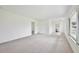 Spacious, light-filled living room with neutral tones and large windows, freshly painted and move-in ready at 216 N Riverside Dr, Edgewater, FL 32132