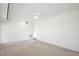 Spacious room featuring neutral carpet, white walls, a ceiling fan, and bright lighting at 216 N Riverside Dr, Edgewater, FL 32132