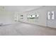 Bright living room with large windows offering a view of the front yard and fresh, neutral paint at 216 N Riverside Dr, Edgewater, FL 32132