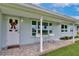 Inviting front porch with seating, offering a cozy space to enjoy the neighborhood views at 216 N Riverside Dr, Edgewater, FL 32132