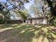 Spacious backyard featuring mature trees, lush greenery, and room for outdoor activities at 2342 Alice Ave, Eustis, FL 32726