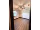 An inviting bedroom featuring wood-look flooring, a modern ceiling fan, and a bright window at 2342 Alice Ave, Eustis, FL 32726