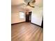 A cozy bedroom features wood-look flooring, a modern ceiling fan and a window for natural light at 2342 Alice Ave, Eustis, FL 32726