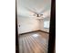 Cozy bedroom with sleek wood flooring, ceiling fan, and natural light at 2342 Alice Ave, Eustis, FL 32726
