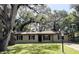 Charming single-story home with a well-manicured lawn and mature trees providing shade at 2342 Alice Ave, Eustis, FL 32726