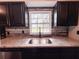Close-up of kitchen sink with granite countertop and stylish cabinetry at 2342 Alice Ave, Eustis, FL 32726