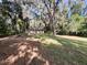 Large private yard with a well-maintained lawn and mature trees, ideal for outdoor activities and relaxation at 2342 Alice Ave, Eustis, FL 32726